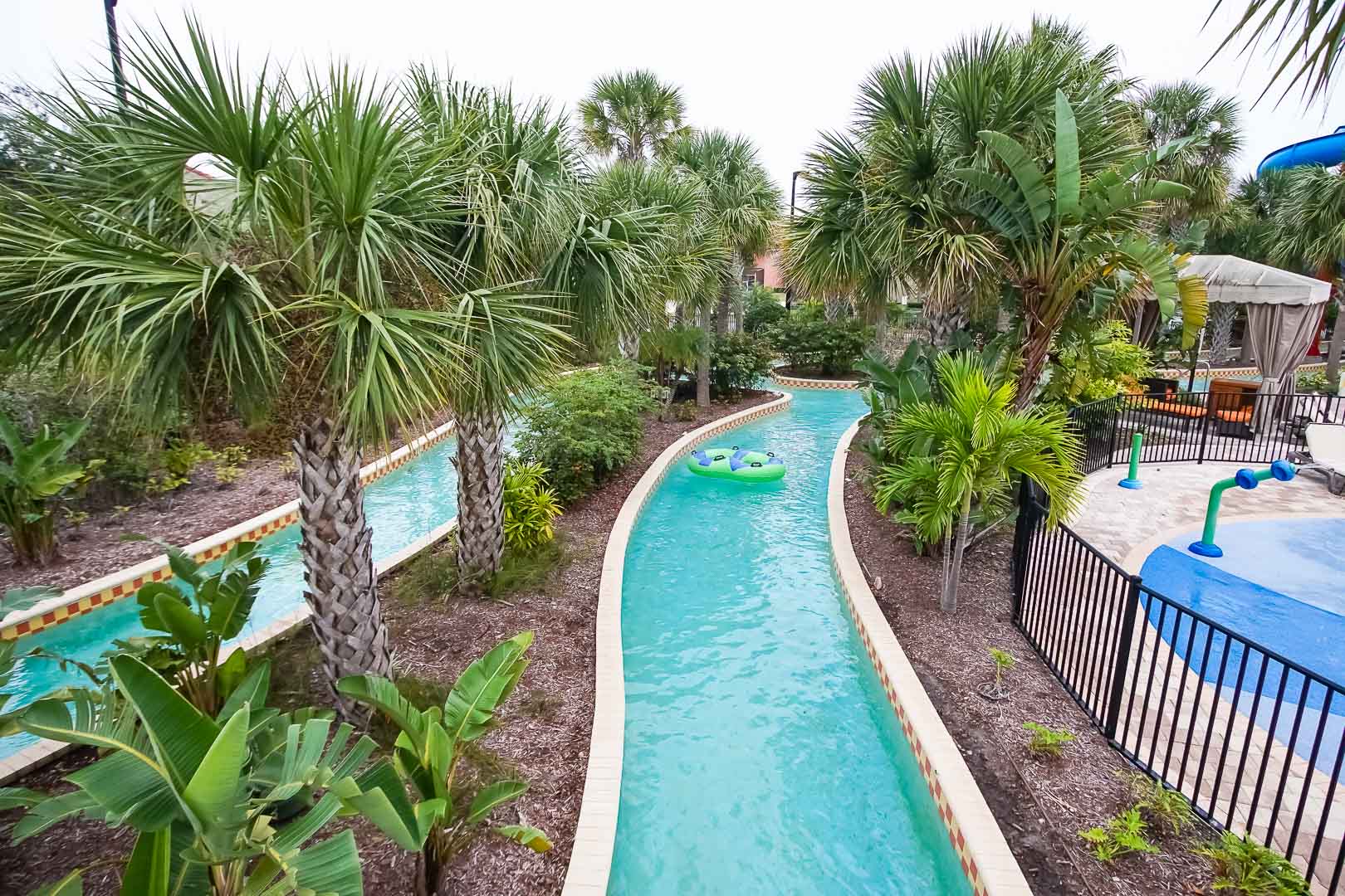 A relaxing view of the outdoor lazy river pool at VRI's Fantasy World Resort in Florida.